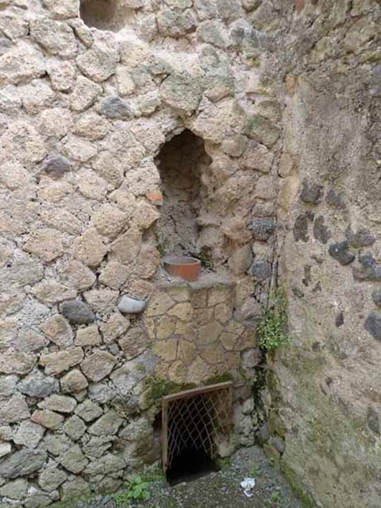 III.4 Herculaneum. May 2010. Down-pipe in wall in south-east corner of second room.